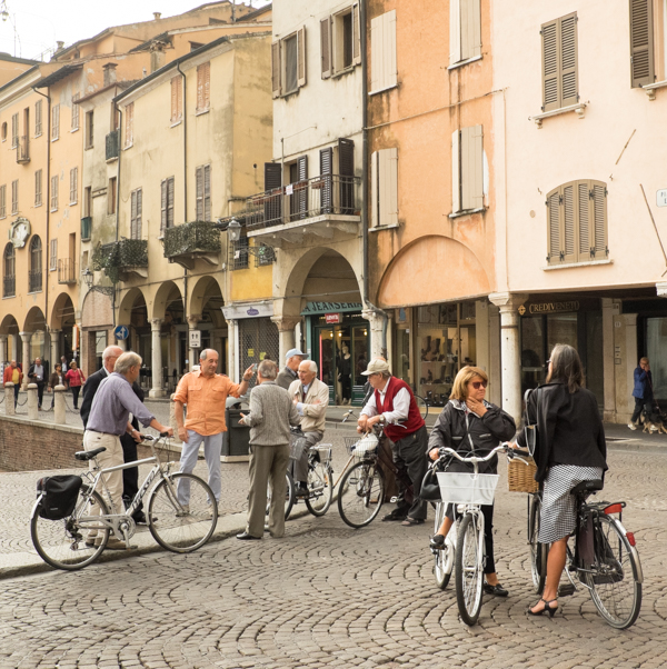 Image of cyclists meet to chat in downtown Mantua, Italy