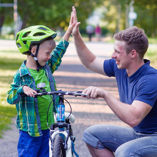 Image of father and son bicycle lesson