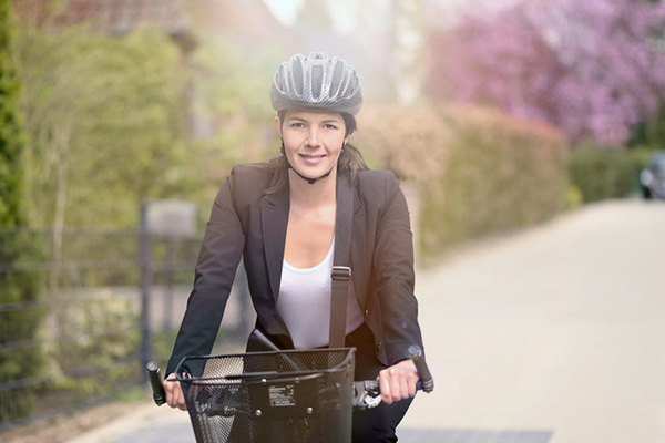 Image of a woman riding a bike in a business suit